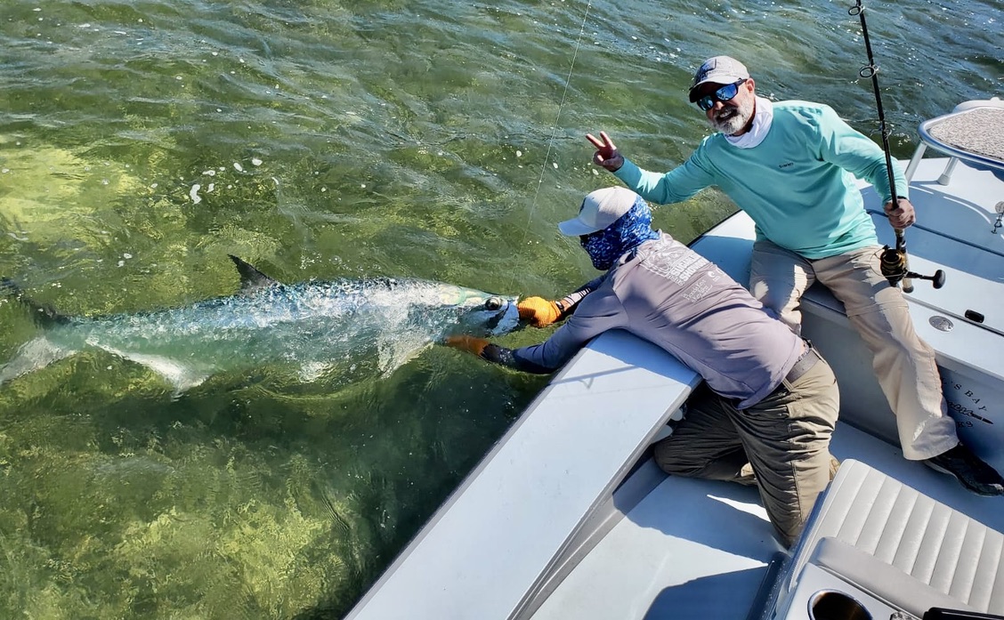 Two men on a tarpon fishing charter.