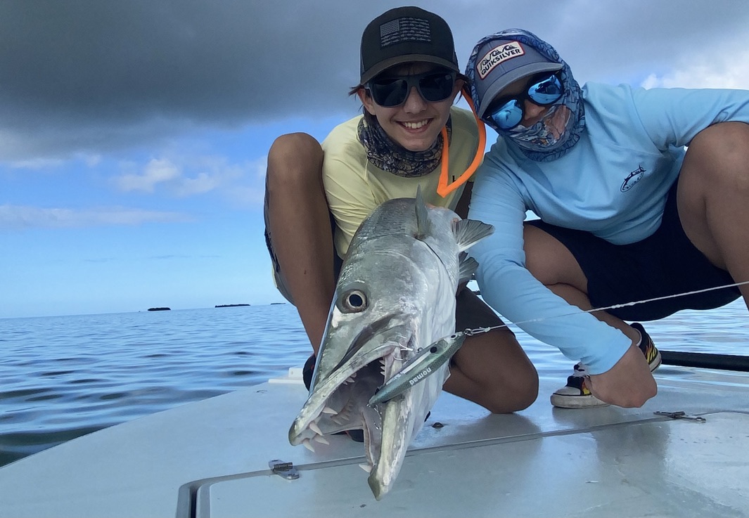 Two kids fun fishing barracuda while on a flats fishing charter.